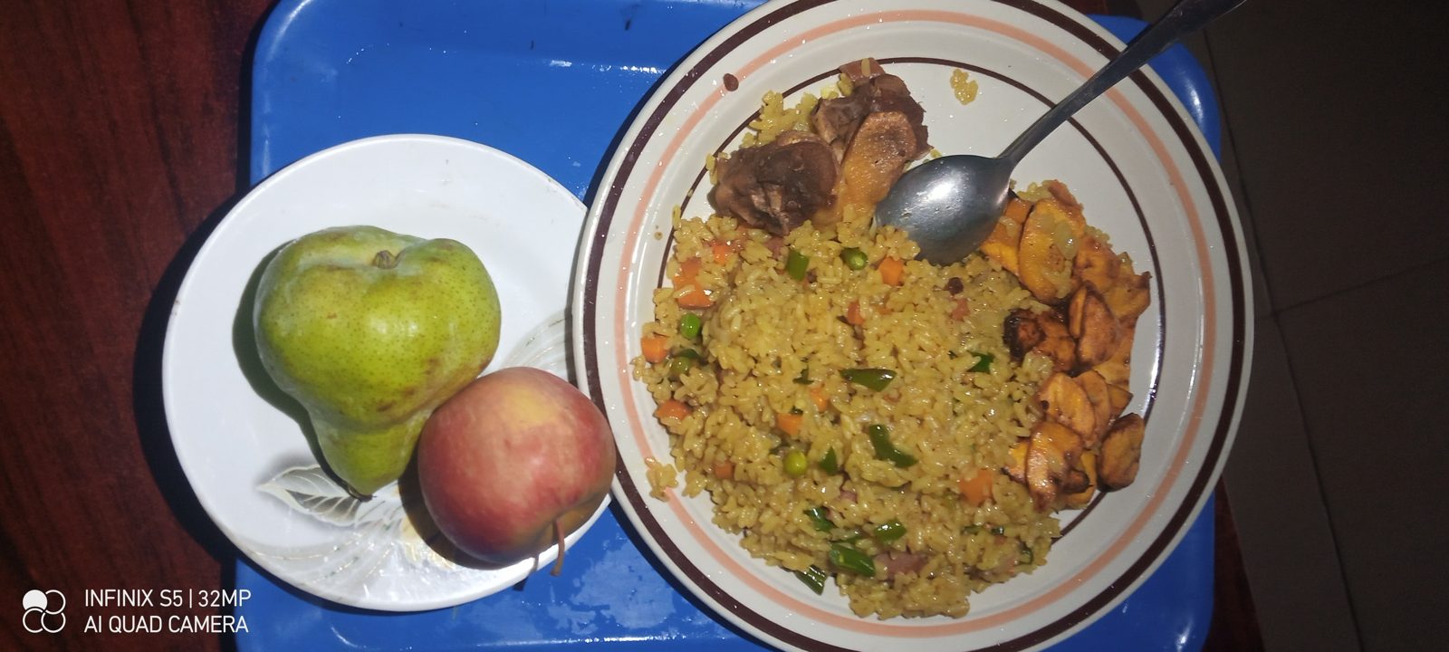 Spread of fried rice, chicken and plantain